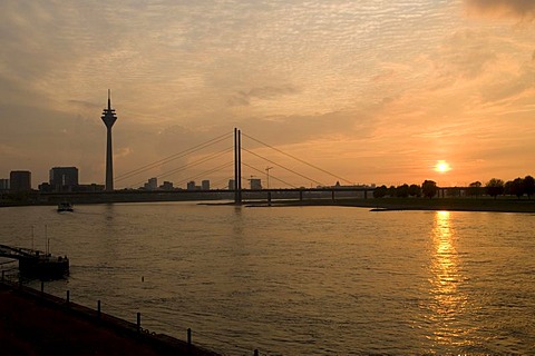 City gate, Rheinturm tower and Rheinkniebruecke bridge in the evening light, state capitol Duesseldorf, North Rhine-Westphalia, Germany, Europe