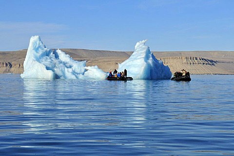 Zodiac with cruiseship passengers near an iceberg at Crocker Bay, Devon Island, Northwest Passage, Nunavut, Canada, Arctic