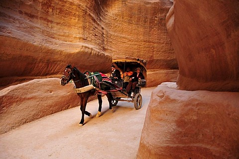 Coach with tourists in the Siq, the one kilometer long canyon that leads to the Nabataean city Petra, Unesco World Heritage Site, near Wadi Musa, Jordan, Middle East, Orient