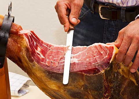 Butcher slicing ham