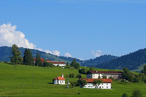 Farm and church at the Weiler-Simmerberg village, Allgaeu, Bavaria, Germany, Europe