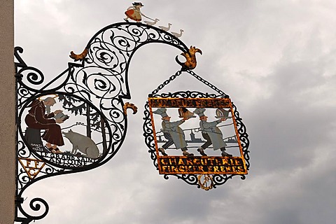 Ornate iron hanging sign of a slaughterhouse "CHARCUTERIE FINCK FRERES" against a rainy sky, Colmar, Alsace, France, Europe