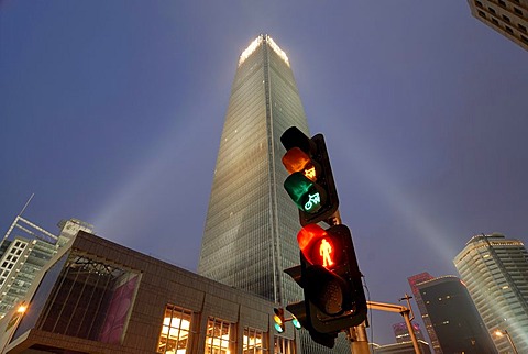 Red yellow green traffic light at the blue hour in front of a modern skyscraper, in Beijing, Guomao District, Beijing, China, Asia