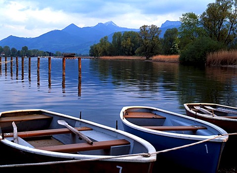 Small boats moored on the Chiemsee lake and Bavarian Alps, Chiemgau, Upper Bavaria, Germany, Europe