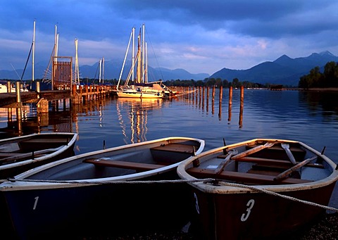 Small boats moored on the Chiemsee lake and Bavarian Alps, Chiemgau, Upper Bavaria, Germany, Europe