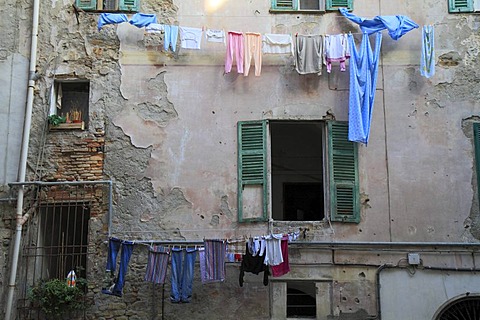 Facade of a house in need of renovation with laundry hanging to dry in the historic town centre of Ventimiglia, province of Imperia, Liguria region, Riviera dei Fiori, Mediterranean Sea, Italy, Europe