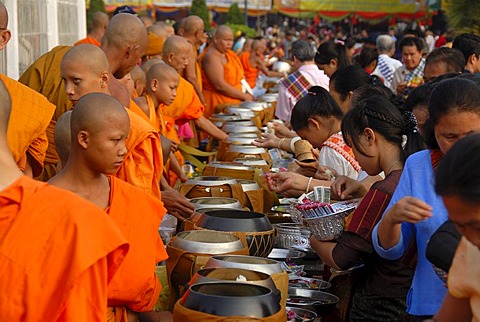 Theravada Buddhism, That Luang Festival, Tak Bat, monks standing behind begging bowls, believers, pilgrims giving alms, orange robes, Vientiane, Laos, Southeast Asia, Asia