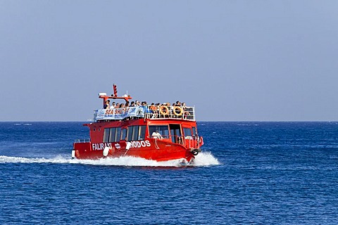 An excursion boat passes the harbor entrance, Rhodes town, Rhodes island, Greece, northern part, Aegean Sea, Southern Europe, Europe