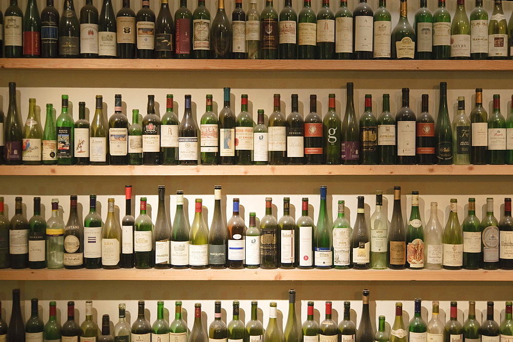 Many empty wine bottles on the shelves in the window of a wine restaurant, Vienna, Austria, Europe