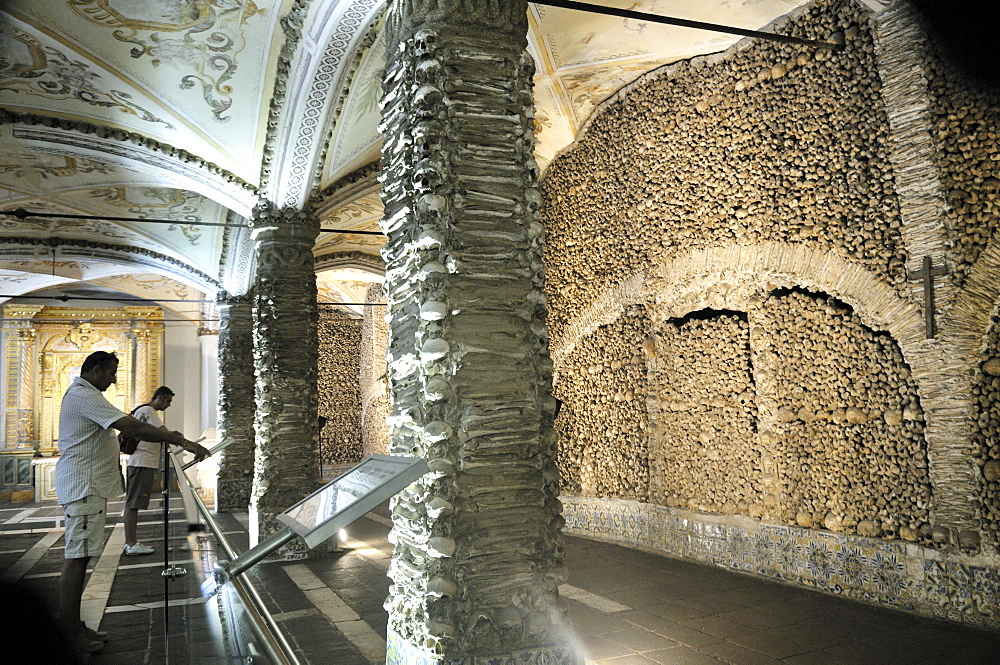 Visitors in the charnel, bones chapel Capela dos Ossos in the Franciscan monastery, Evora, UNESCO World Heritage Site, Alentejo, Portugal, Europe