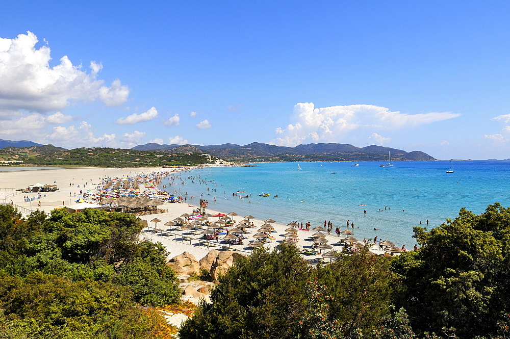 Bathing tourists and colorful parasols on the beach, crystal clear turquoise water, Cala Giunco, Porto Giunco, Capo Carbonara, Villasimius, Sardinia, Italy, Europe