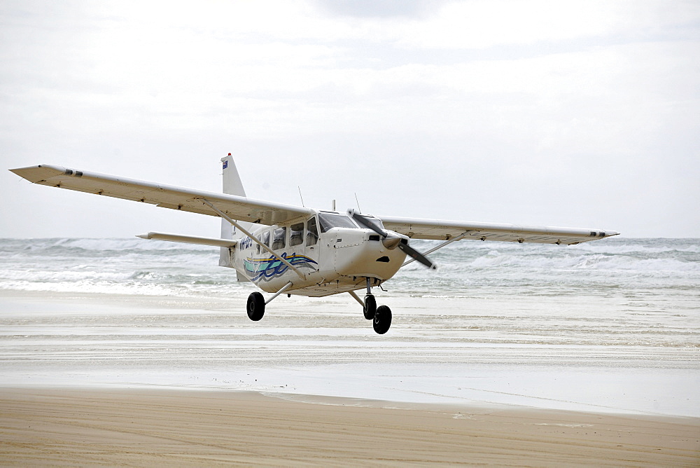 Aircraft on Seventy-Five Mile Beach, an official highway, the world's only official beach airport on a sand runway, UNESCO World Natural Heritage Site, Fraser Island, Great Sandy National Park, Queensland, Australia