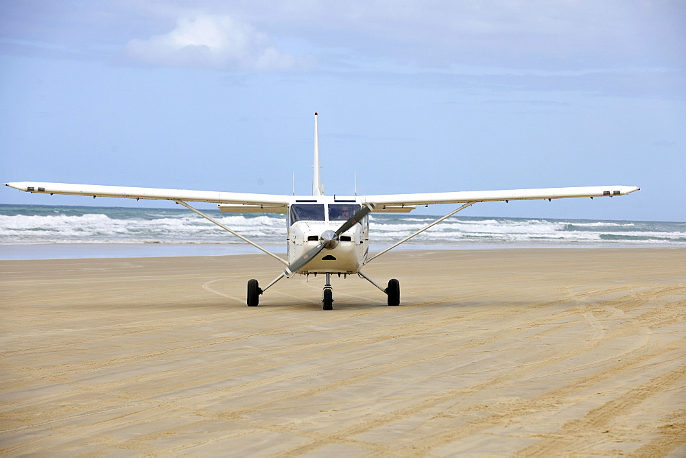 Aircraft on Seventy-Five Mile Beach, an official highway, the world's only official beach airport on a sand runway, UNESCO World Natural Heritage Site, Fraser Island, Great Sandy National Park, Queensland, Australia