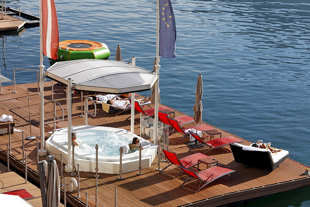 Roofed jacuzzi, pool and wellness platform in the Wolfgangsee lake, hotel Im Weissen Roessl, St. Wolfgang, Salzkammergut region, Upper Austria, Austria, Europe