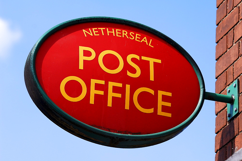 Post office sign at a grocery store against a blue sky, Netherseal, South Derbyshire, England, UK, Europe