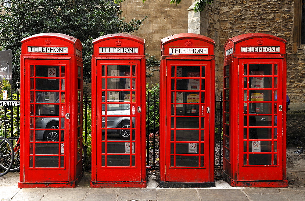 Four English red telephone booths, St. Mary's Street, Cambridge, Cambridgeshire, England, United Kingdom, Europe