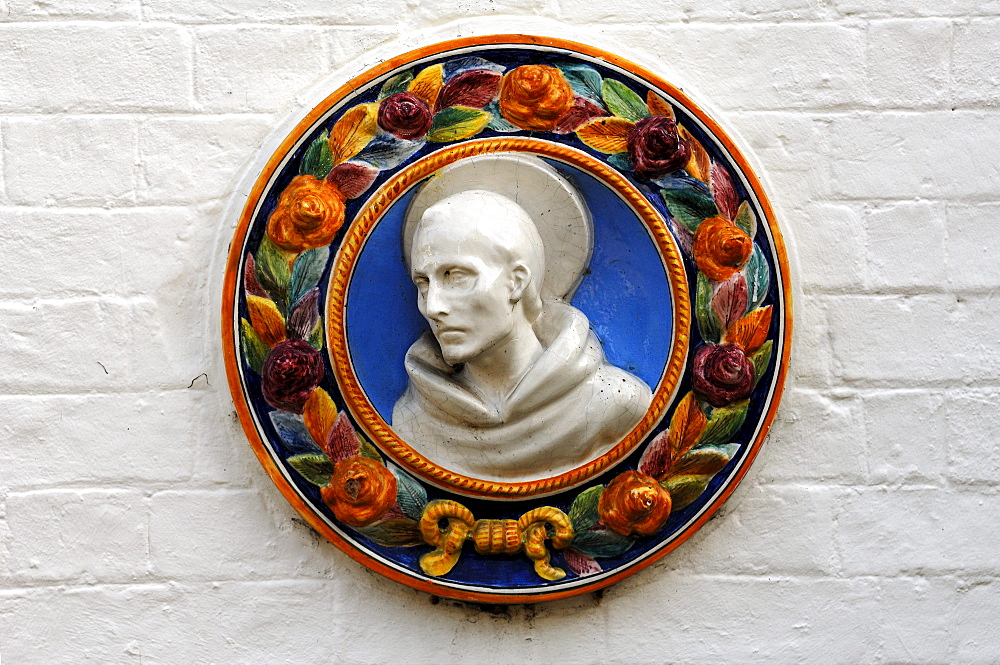 Ceramic figure of St. Francis on a community hall, High Street, Hemingford Gray, Cambridgeshire, England, United Kingdom, Europe