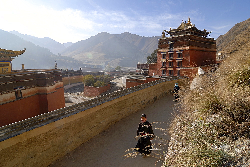 Tibetan women in traditional costume at the morning circling, Kora, of the Labrang monastery, Xiahe, Gansu, China, Asia