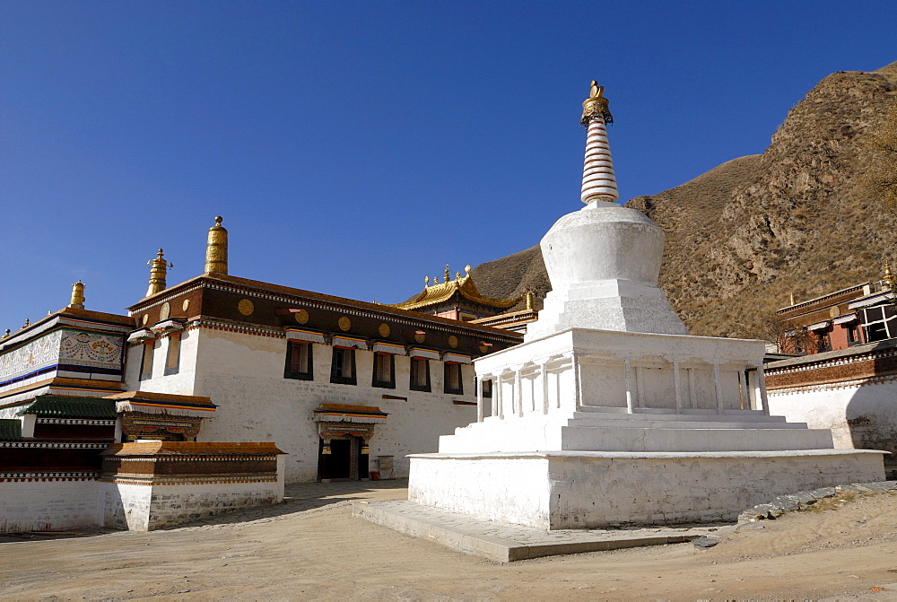 Large white stupa and monastery building of Labrang Monastery, Xiahe, Gansu, China, Asia