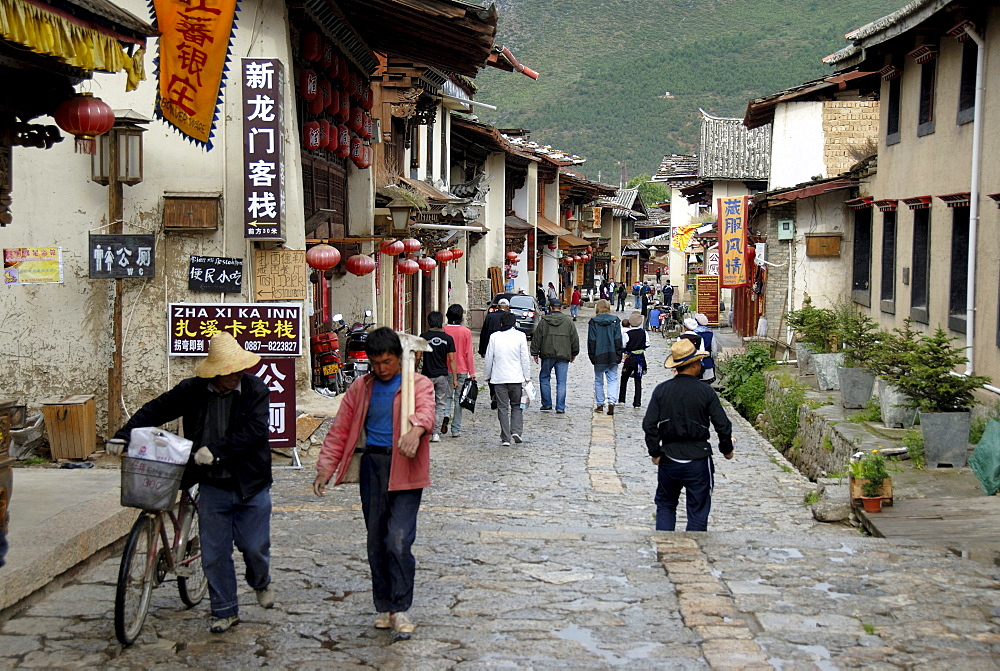 Locals and tourists in a street in the old town of the Tibetan city Zhongdian, Shangri-La, Yunnan Province, People's Republic of China, Asia