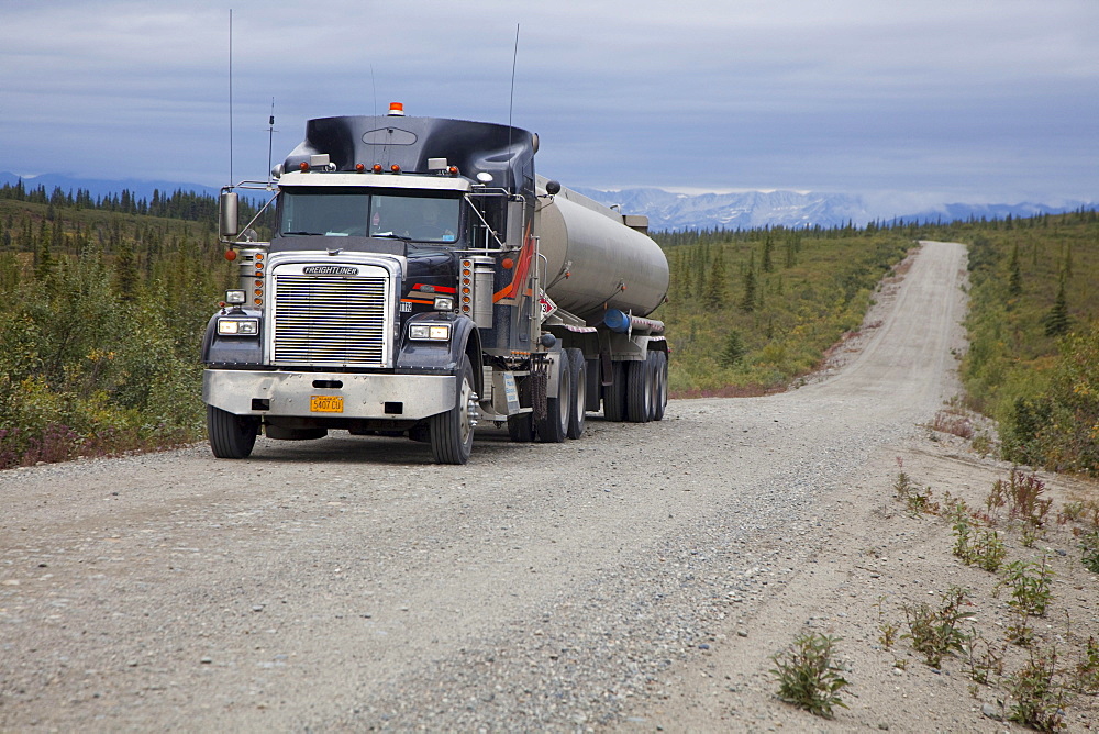 A fuel tank truck on the Denali Highway, a little-used 135-mile long mostly unpaved road which traverses the remote wilderness east of Denali National Park, Alaska, USA