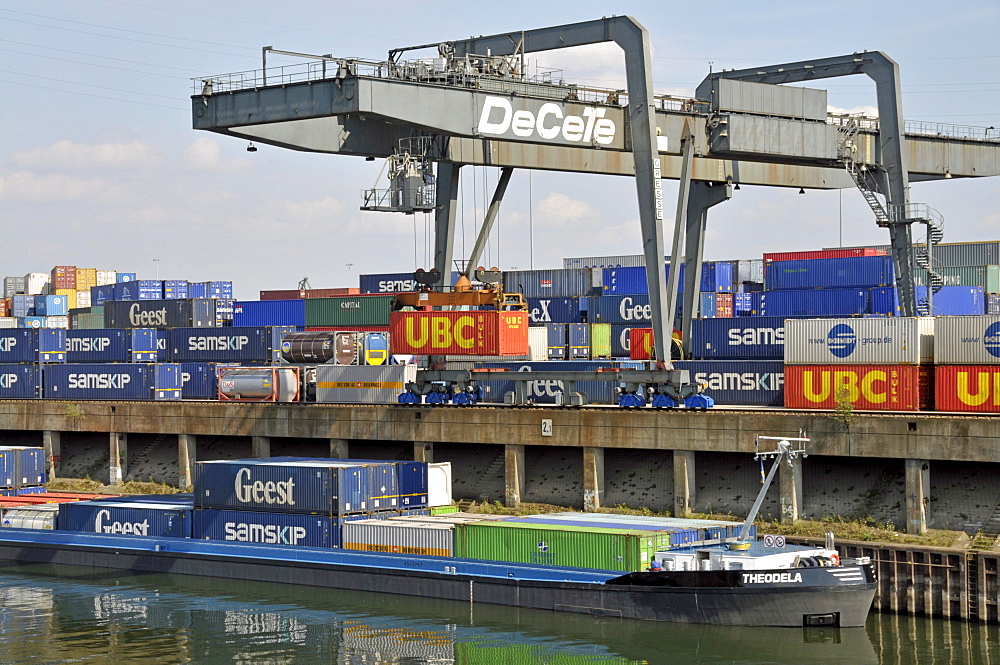 Cargo ship is being loaded, inland port in Duisburg, North Rhine-Westphalia, Germany, Europe