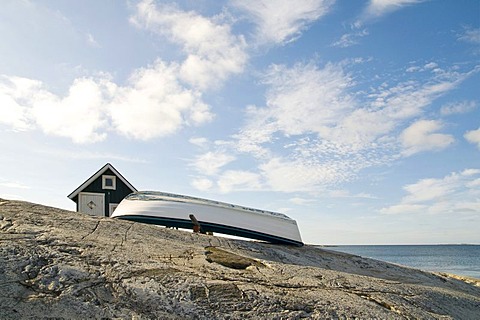 Wooden shed and boat on the rocky coast, Smoegen, Bohuslaen, Sweden