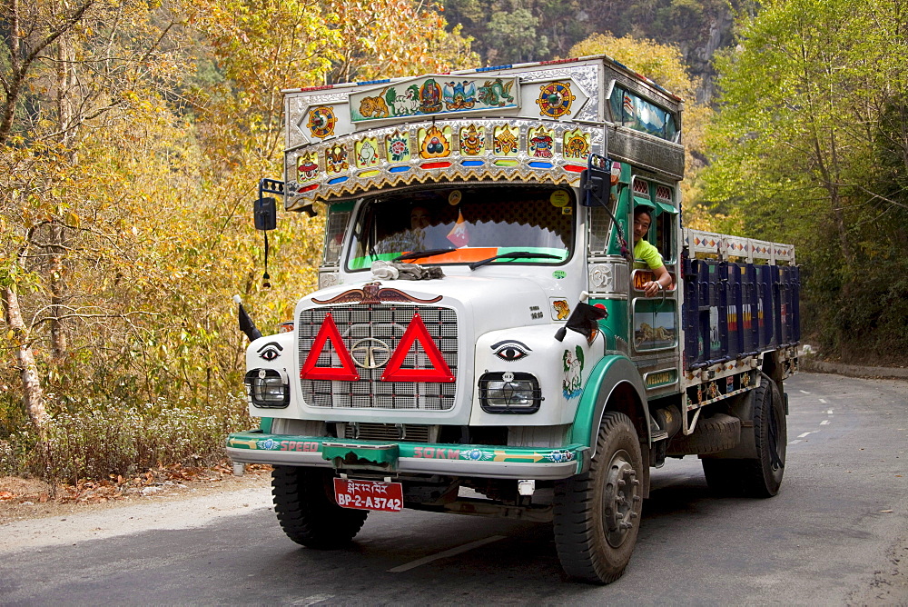 Decorated colourful heavy goods lorry TATA in mountain road, Bhutan, South Asia