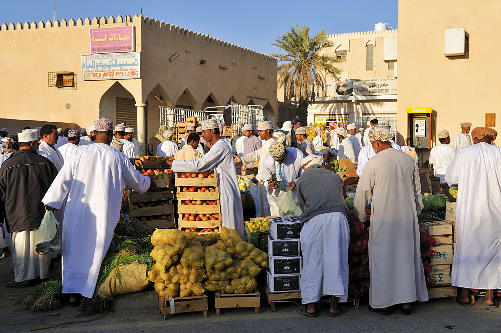 Omani men in traditional dress, Bahla vegetable market, Hajar al Gharbi Mountains, Al Dakhliyah region, Sultanate of Oman, Arabia, Middle East