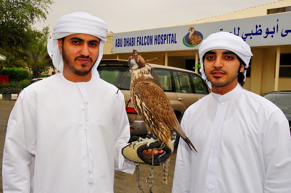 Two locals with their falcons at the Abu Dhabi Falcon Hospital, Abu Dhabi, United Arab Emirates, Arabia, Middle East, Orient