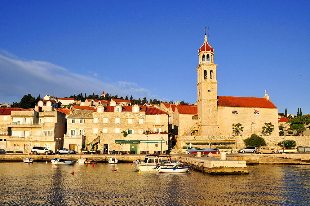 Fishing boats in the harbor of Sutivan in front of the church Sveti Ivan, Island Brac, Dalmatia, Croatia, Balkans, Europe