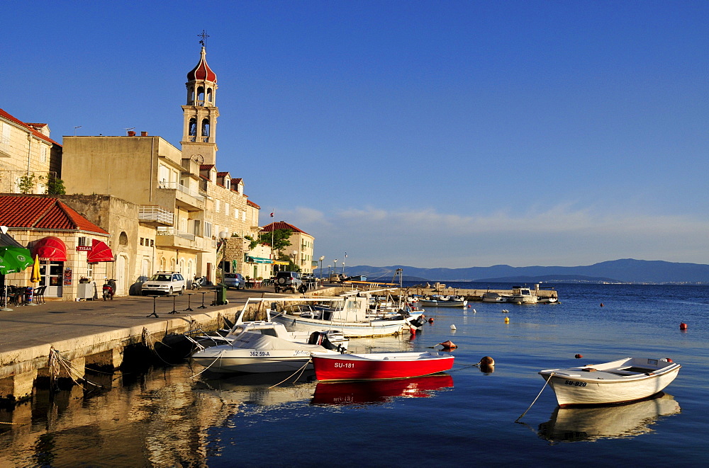 Fishing boats in the harbor of Sutivan in front of the church Sveti Ivan, Island Brac, Dalmatia, Croatia, Balkans, Europe