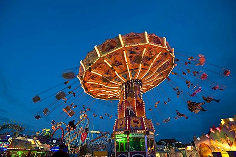 Illuminated Chairoplane at dusk, Oktoberfest festival, Munich, Bavaria, Germany