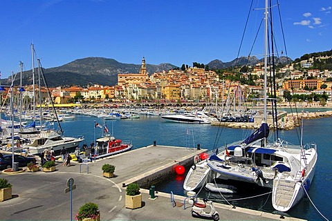 Catamaran by the marina at the old port of Menton, Cote d'Azur, France