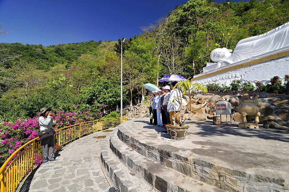 Photographer taking a picture of a woman on the mountain of the Black woman, Nui Ba Den, Tay Ninh, Vietnam, Asia