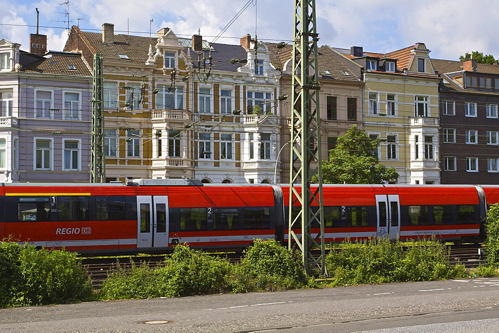 Regional train from Deutsche Bahn AG in front of Gruenderzeit buildings, from the Founder's Epoch period, in the city of Bonn, North Rhine-Westphalia, Germany, Europe