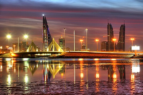 Skyline of the Corniche as seen from King Faisal Highway, Muharraq side, World Trade Center buildings, left, beside the towers of the Financial Harbour Complex, Muharriq Bridge at the Sheikh Isa Causeway, capital city, Manama, Kingdom of Bahrain, Persian 