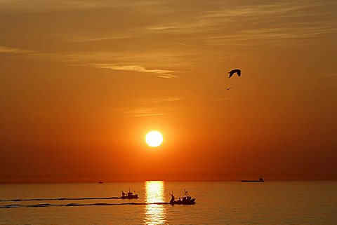 Atlantic Ocean at sun set. Fisherboats . Normandy , France , Europe