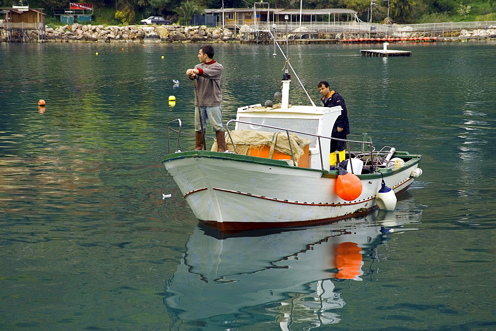 Fishermen and fishing boat at harbor Castellammare del Golfo, Sicily, Italy, Europe