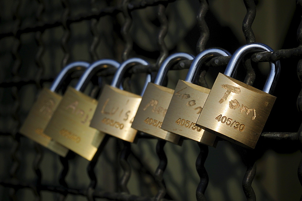 Padlocks as a symbol of friendship and love on the fence of the Hohenzollern bridge in Cologne, North Rhine-Westphalia, Germany, Europe