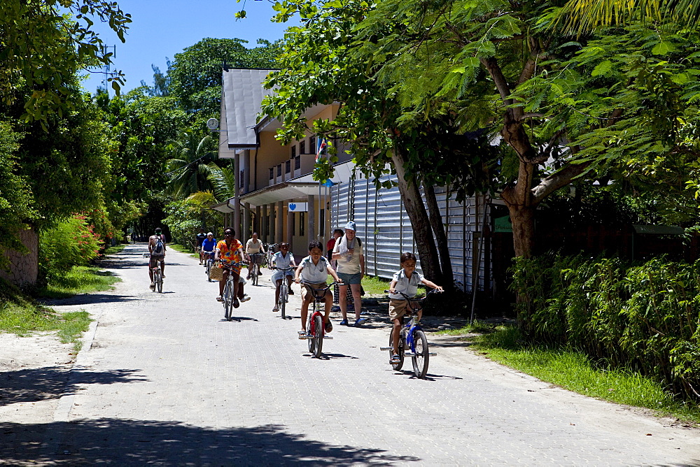 Tourists on bicycles, La Digue Island, Seychelles, Indian Ocean, Africa