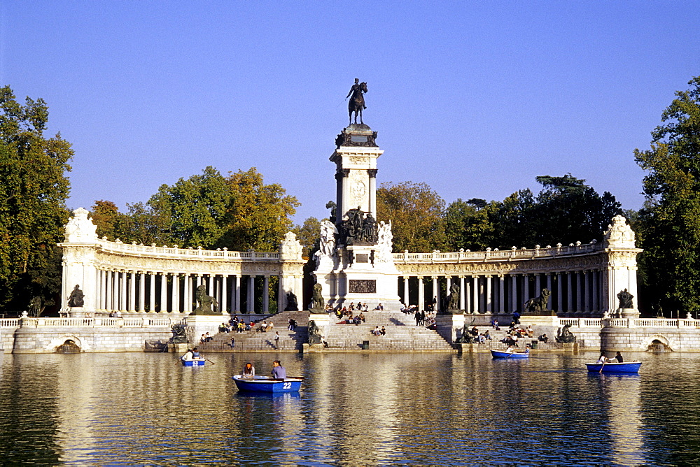 Colonnade and equestrian statue of the monument to Alfonso XII, Glorieta de la Sardana on Estanque, rowboats on the lake in the park, Parque del Retiro, Madrid, Spain, Europe