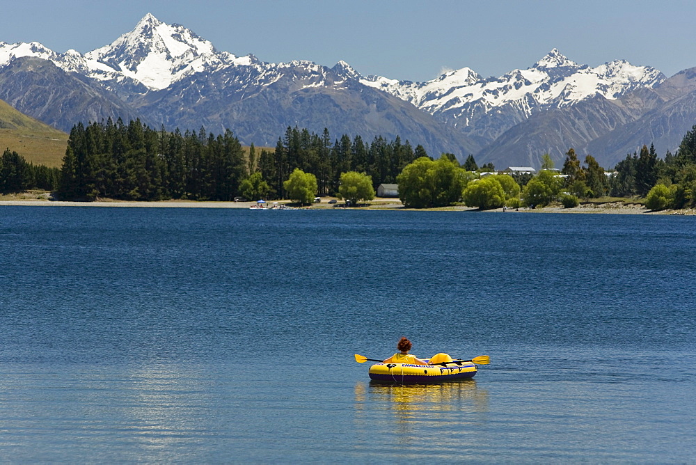 Inflatable boat on Lake Camp with views of the mountains of Cloudy Peak Range, South Island, New Zealand