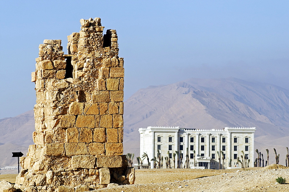 Grave tower and modern hotel in the valley of graves, Palmyra excavation site, Tadmur, Syria, Asia