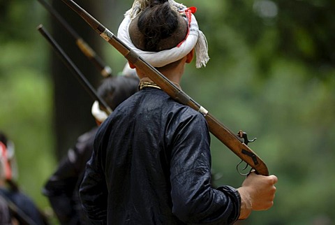 Man of the Basha minority with a gun at a shooting ceremony, Basha, Guizhou, China, Asia