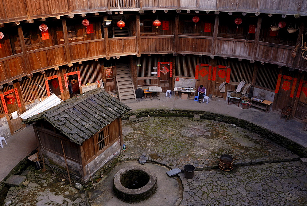 Courtyard with a fountain of a Tulou round house, dirt round houses, adobe round houses, the Chinese minority Hakka, near Yongding and Hukeng, Fujian, China