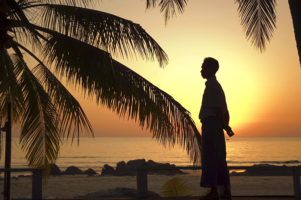 Burmese in front of sunset, palm beach, Ngapali Beach, Thandwe, Rakhine Coast, Bay of Bengal, Burma, Myanmar, Asia