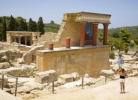 Tourists visiting and taking pictures of the arcade of columns at the northern entrance of the palace on the grounds of the Minoan excavation of Knossos, Heraklion, island of Crete, Greece, Europe