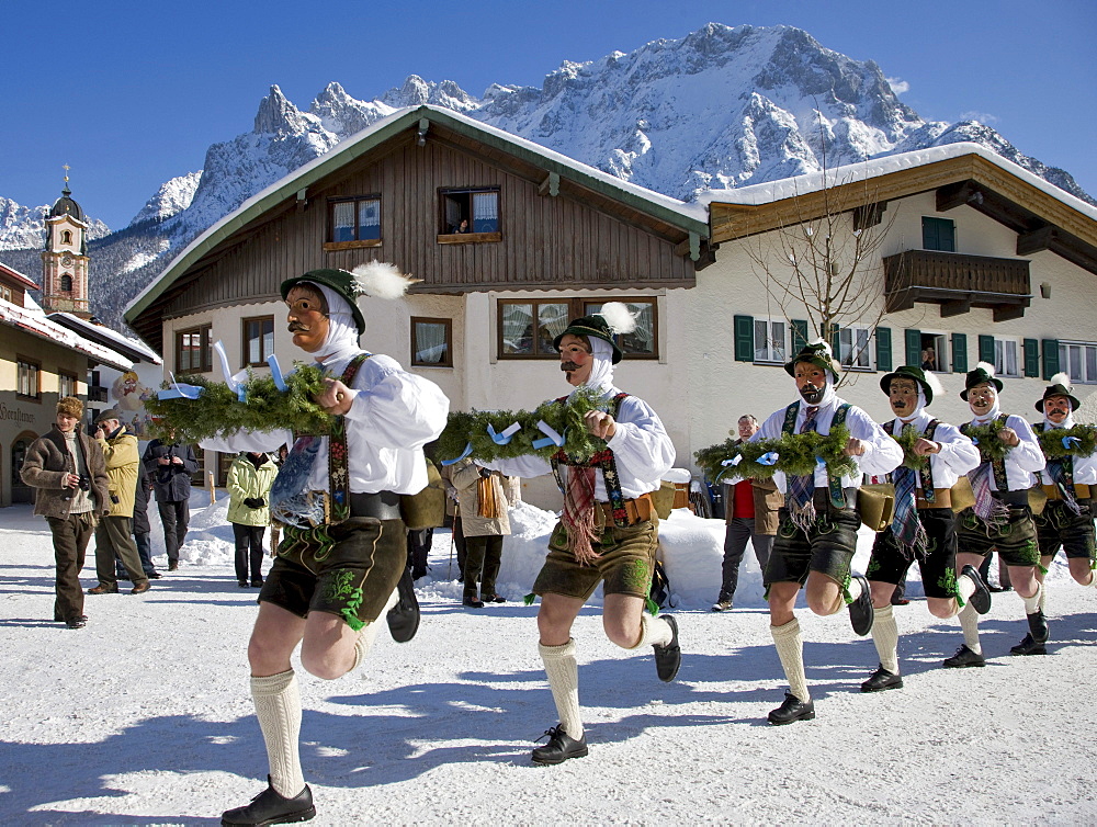 "Schellenruehrer" bell ringers, carnival, Parish church, Karwendelgebirge mountains, Mittenwald, Werdenfels, Upper Bavaria, Bavaria, Germany, Europe