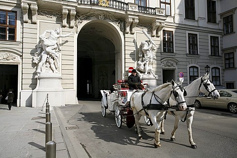 Fiaker, horse drawn carriage, entering the Heldenplatz, Heroe's Square through the Hofburg Castle, Vienna, Austria